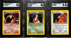 Lot of (3) SGC Graded 2000s Pokemon Holo Cards - 2000 Team Rocket Dark Charizard (SGC 8), 2000 Neo Genesis 1st Edition Meganium (SGC 8), 2001 Neo Discovery Ursaring (SGC 8.5)
