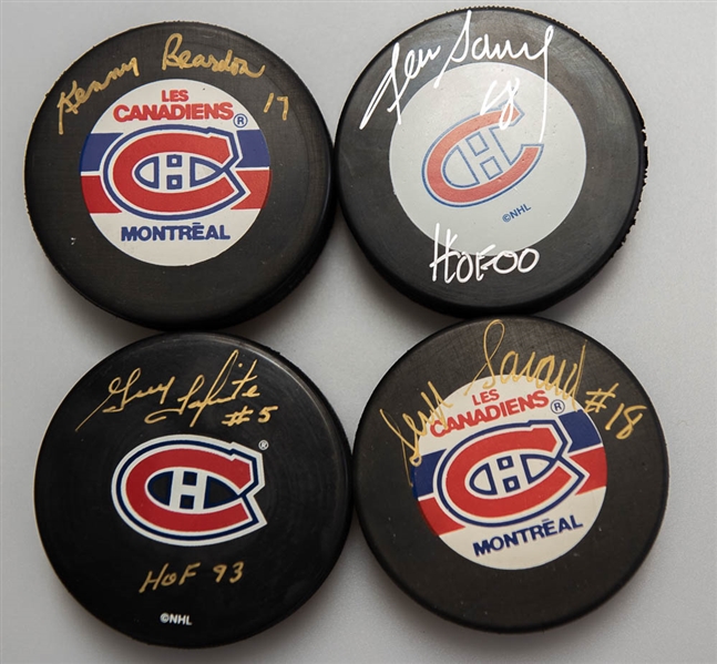 Lot of (4) Signed Montreal Canadiens Hockey Pucks (Serge Savard, Denis Savard, Guy Lapointe, Ken Reardon)  - JSA Auction Letter