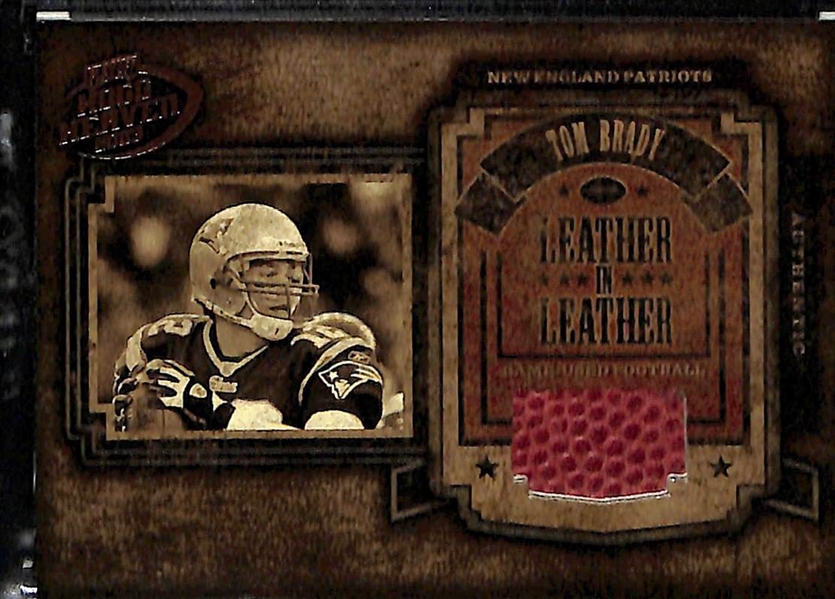 (2) Tom Brady Game-Used Football Relic Cards (2002 Donruss Leather Kings #163/250; and 2003 Playoff Hogg Heaven Leather in Leather #57/250)