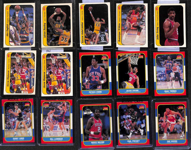 Lot of (75+) 1986-87 Fleer Basketball Cards w. Patrick Ewing, Isiah Thomas and (7) Stickers w. Wilkins, Olajuwon, Abdul-Jabbar and More!