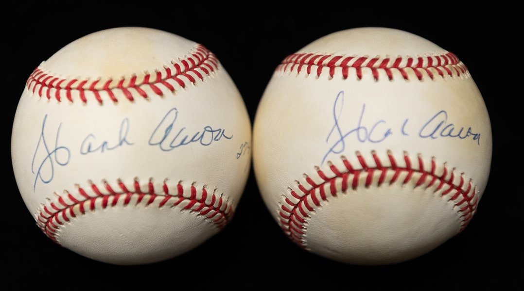 Lot of (2) Hank Aaron Autographed Baseballs w. 1 Official National League and 1 Jackie Robinson 50th Anniversary Ball #d 274/1947 (JSA Auction Letter)