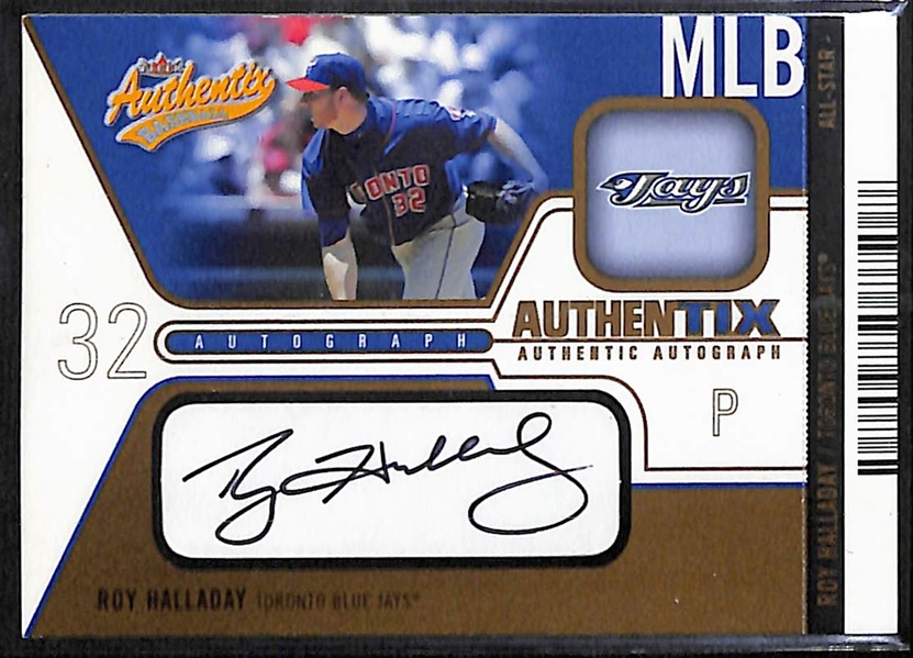 2004 Fleer Authentix & 2005 Skybox Autographics Roy Halladay Autographed Baseball Cards Both #d /75