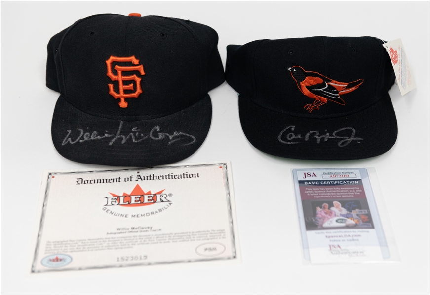 Lot of (2) Autographed Baseball Hats w. Cal Ripken Jr. and Willie McCovey (JSA and Fleer Certs)