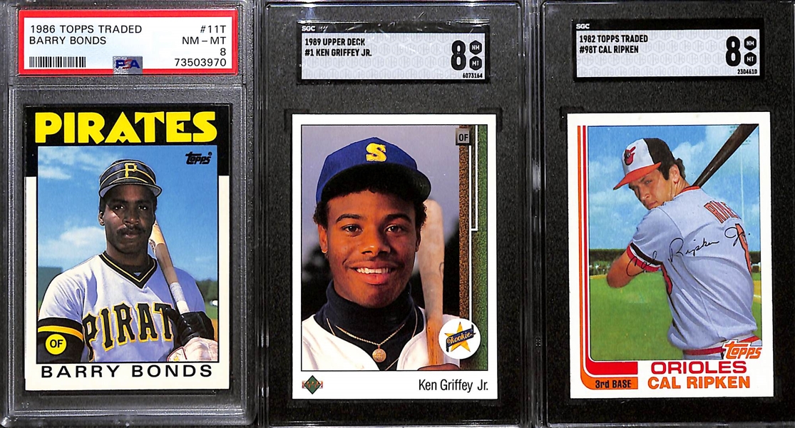 Lot of (3) 1980s Graded Rookie Cards w. 1982 Topps Traded Cal Ripken SGC 8, 1989 Upper Deck Ken Griffey Jr. SGC 8 and 1986 Topps Traded Barry Bonds PSA 8