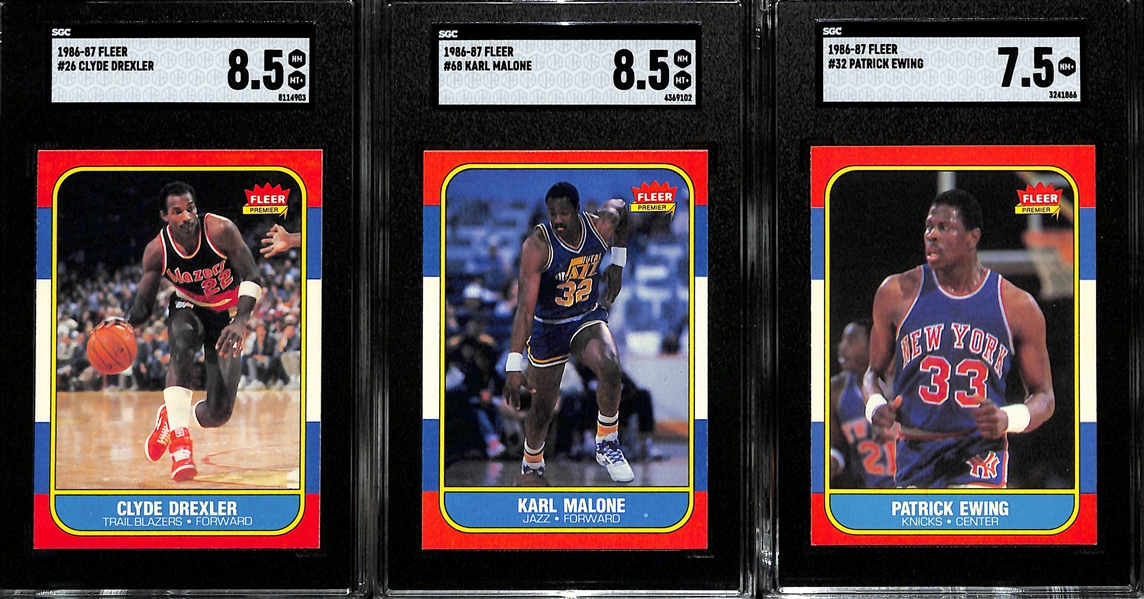 1986-87 Fleer Basketball Rookie Lot - Clyde Drexler #26 (SGC 8.5), Karl Malone #68 (SGC 8.5), & Patrick Ewing #32 (SGC 7.5)