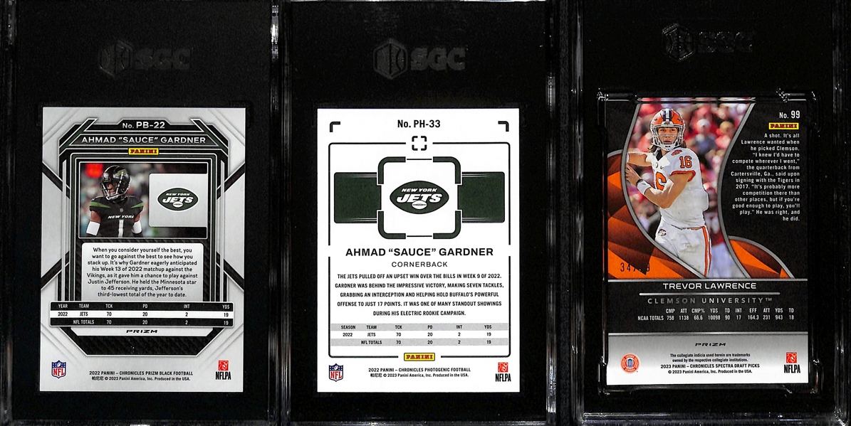 Lot of (3) SGC Graded Football Cards inc. 2022 Chronicles Prizm Black Ahmad Sauce Gardner Orange Rookie (SGC 9) (#/75), 2022 Chronicles Photogenic Ahmad Sauce Gardner Red Rookie (SGC 9.5) (#/199), +